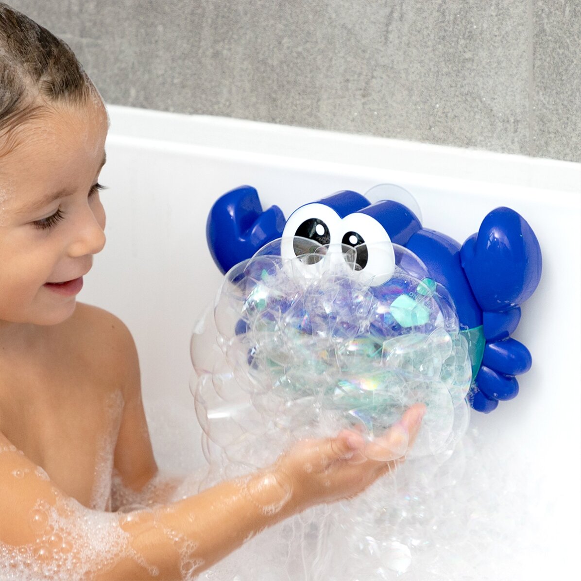 Juguete de baño: cangrejo musical con lanzador de globos