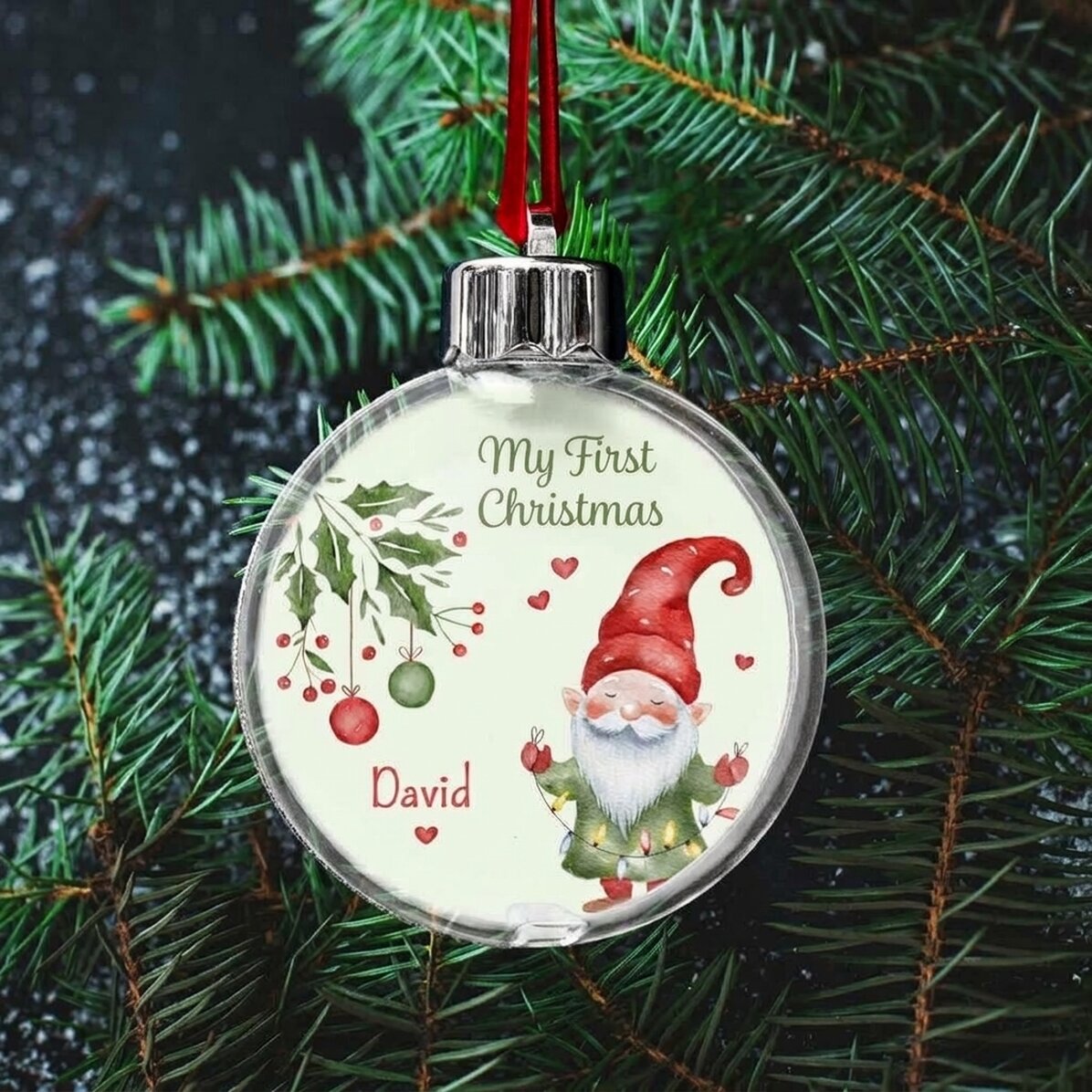Bola de Navidad transparente personalizada por ambos lados con una foto y un mensaje: «Mi primera Na