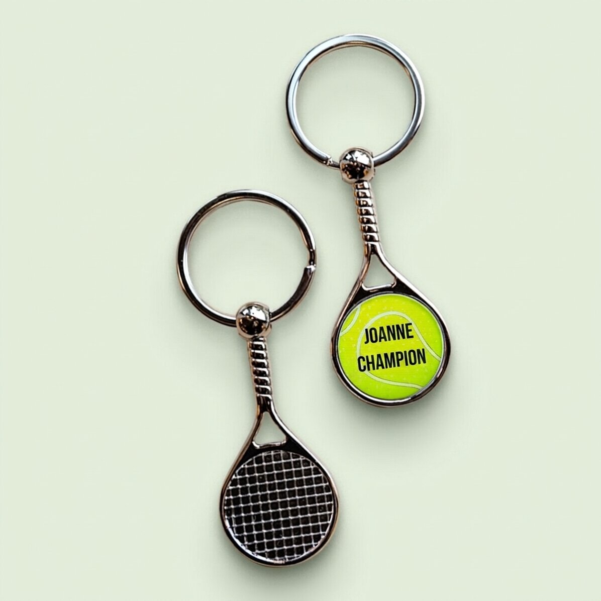 Llavero con forma de raqueta de tenis personalizado con el texto «Campeón»